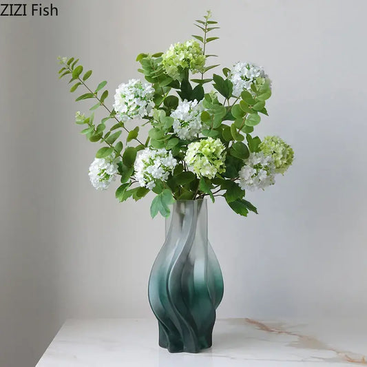 A modern decorbites green ripple glass vase in teal with hydrangeas and eucalyptus for living room decor