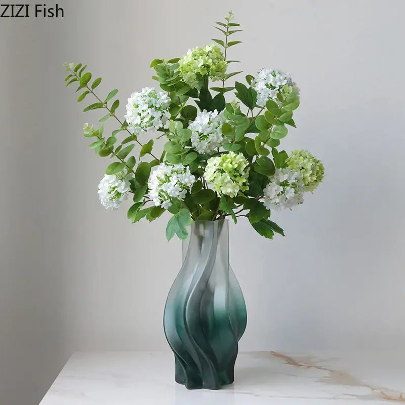 A modern decorbites green ripple glass vase in teal with hydrangeas and eucalyptus for living room decor