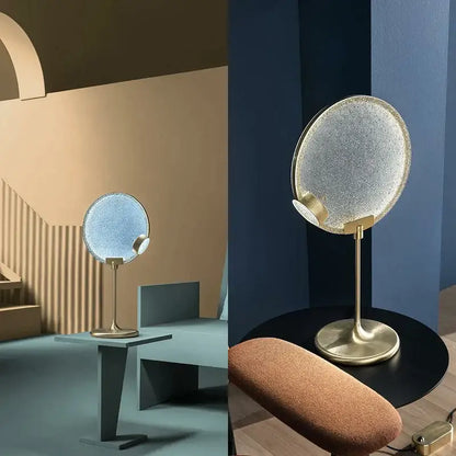 A sleek circular vanity mirror with textured frosted glass and polished brass stand coordinating with decorbites brass pendant light