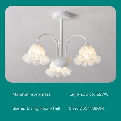 White chandelier ceiling light with three arms and delicate ruffled glass shades in modern green white design