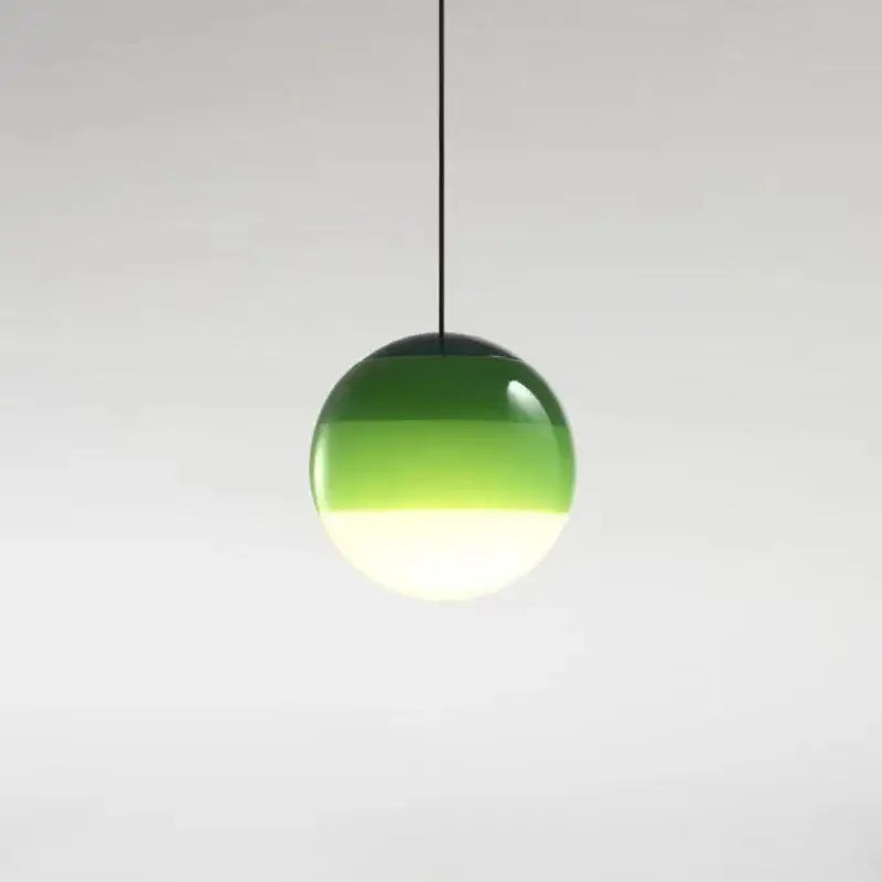 A sleek modern green and white glass ball led pendant with gradient globe and black cord for dining room decorbites lighting