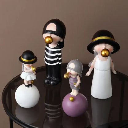 Set of four whimsical green and white polka dot resin bubble gum blowing statues with black hats for living room decor