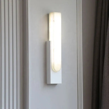 Modern grey marble led wall sconce with white rectangular frosted glass diffuser emitting warm bedside light decorbites grey marble