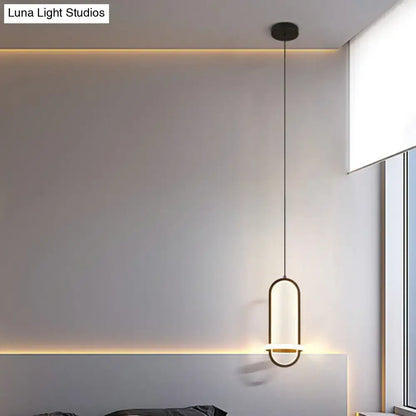Modern halo ring bedside pendant light with sleek black metal frame and warm diffused led glow for bedroom use