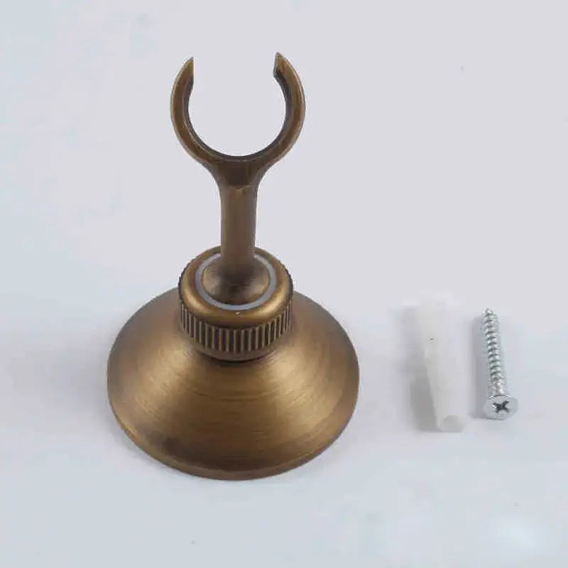 Modern brass-colored metal handshower bracket wall mounted holder with circular base and curved hook by decorbites