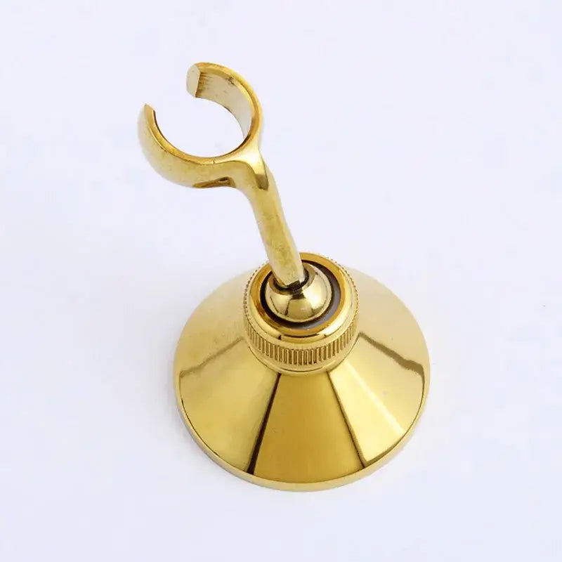 Gold-colored brass handshower bracket wall mounted holder with sleek curved hook and flared base by decorbites