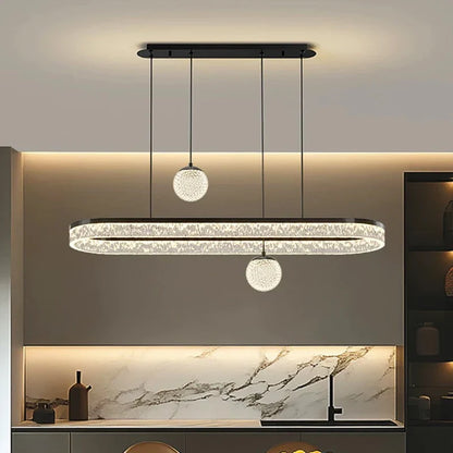 Modern oval-shaped crystal chandelier with spherical pendant lights, black metal frame, and clear faceted crystals for indoor use