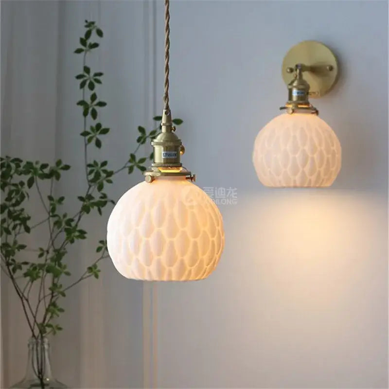 Antique brass-finished modern honeycomb ceramic led wall sconce with frosted glass globes for bedroom decorbites ceramic led lighting