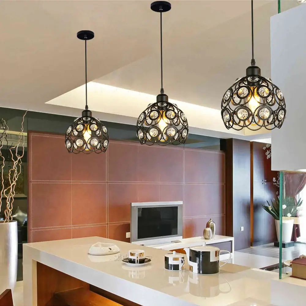 Three black wrought iron pendant lamps with crystal k9 accents hang above a modern kitchen island decorbites crystal pendant lamp