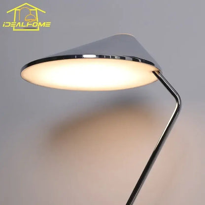 Modern chrome floor lamp with sleek conical shade and warm light featuring decorbites iron art decorative design