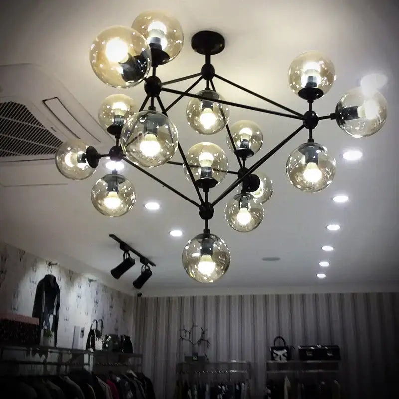Modern industrial pendant light with multiple spherical glass bean bulbs on black metal frame for living room decorbites glass bean