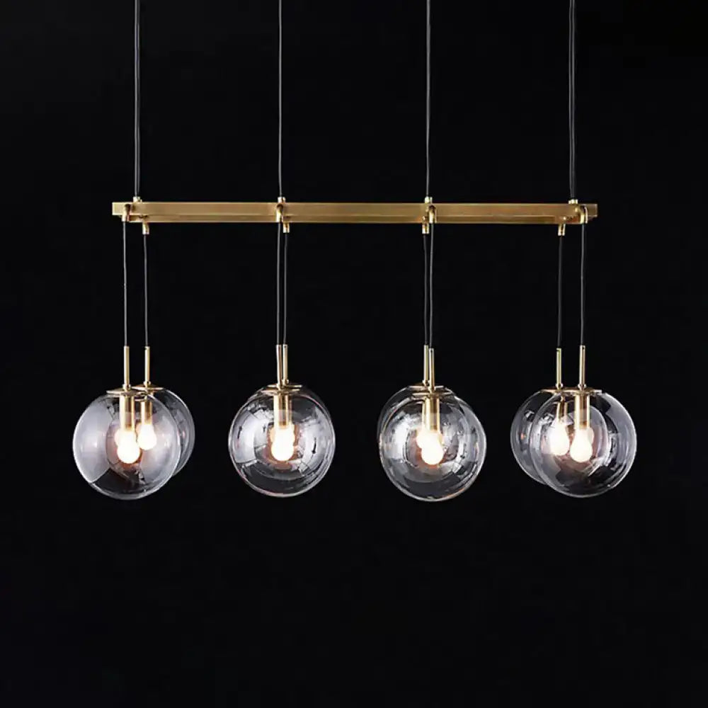 Modern brass bar pendant light with four clear glass globe shades for industrial smoke glass island lighting decorbites fixture