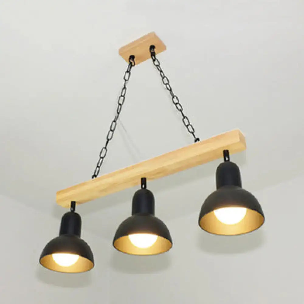 DecorBites modern black metal island light with gold interior hangs from a wooden beam for dining table use