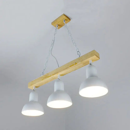 Modern farmhouse-style island light with natural wood beam and three white matte shades for dining table decor