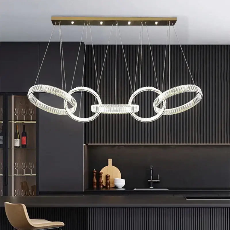 Modern gold-toned decorbites crystal chandelier pendant light featuring four interlocking crystal rings for ceiling lighting