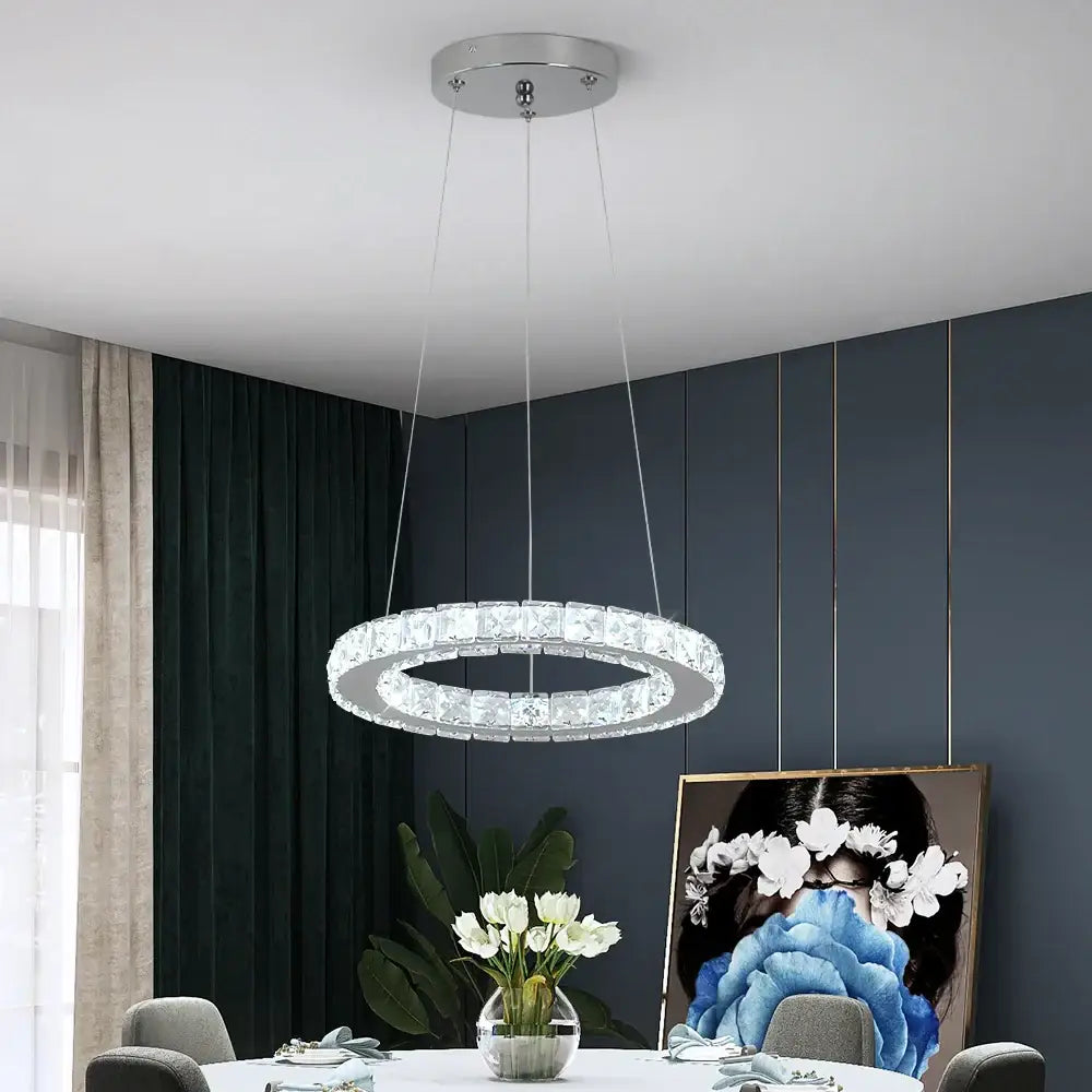 Modern silver-toned crystal led chandelier with interlocking rings and embedded clear faceted stones for living room light