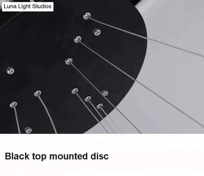 Black top-mounted disc with silver metal tuning pegs and strings featured in modern pendant lights for dining room
