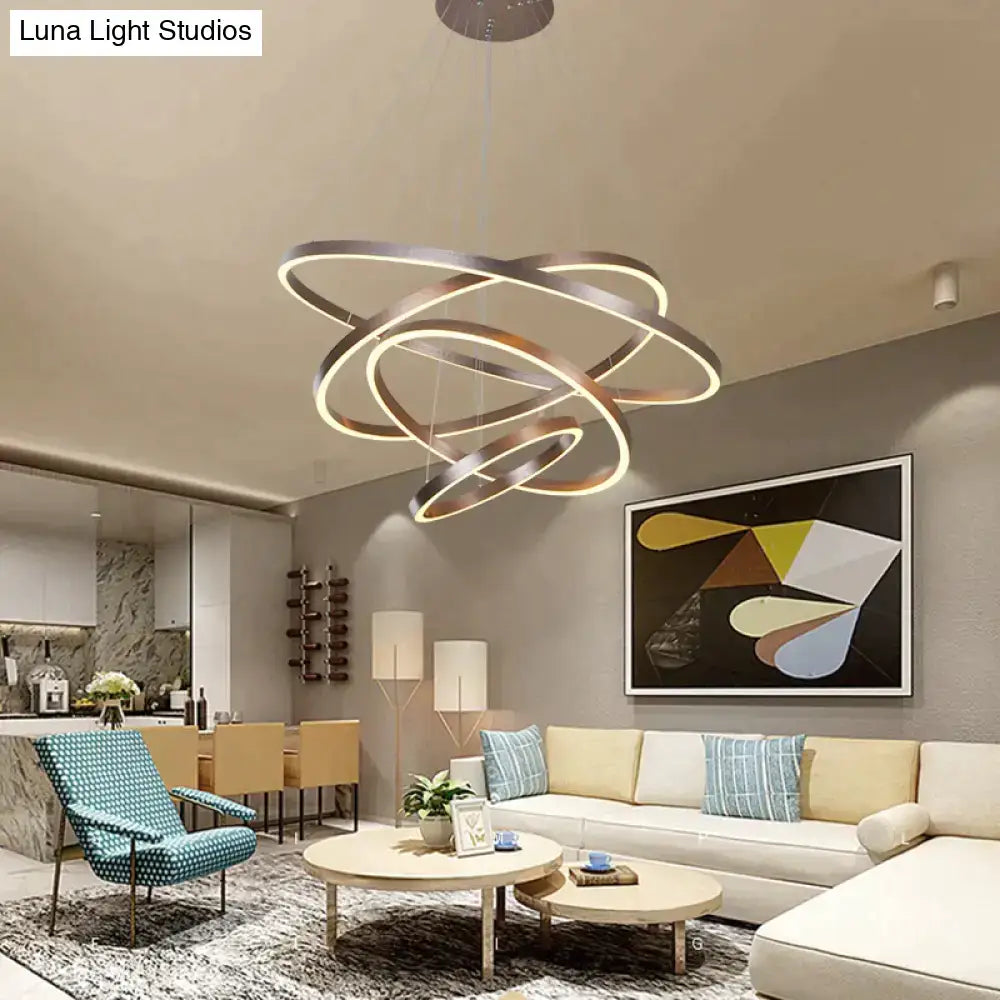 Modern pendant lights featuring metallic interlocking circular rings with warm led illumination for dining room