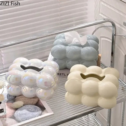 Three glossy ceramic tissue boxes in iridescent white blue and cream with a bubbly decorbites cotton candy design