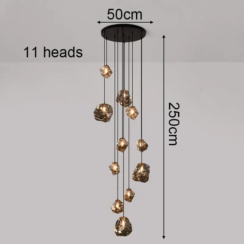 Black iron pendant light with 11 golden glass pendants cascades as a statement piece focal point for dining rooms