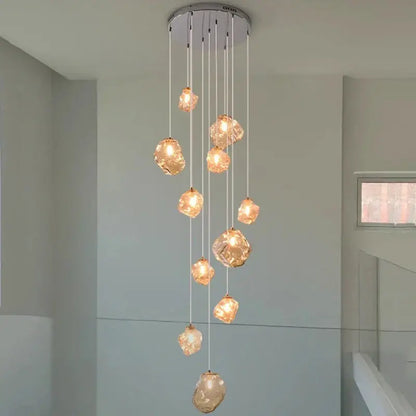 Modern iron and glass pendant light with amber glass globes and chrome fixture serving as a dining room statement piece