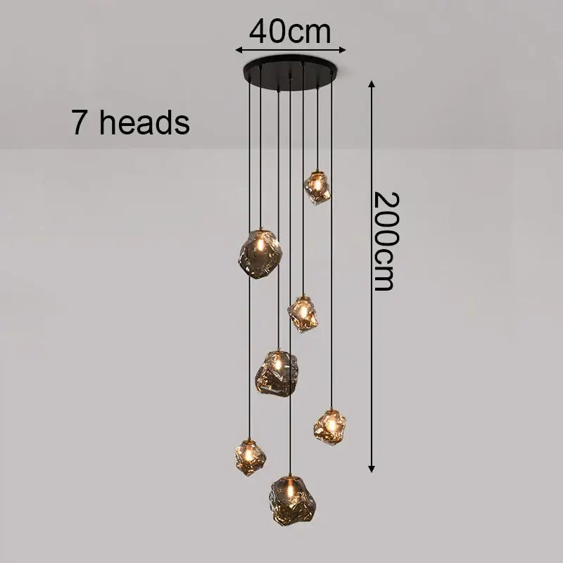 Modern iron and glass black pendant light with seven amber-gold glass shades as a dining room statement piece