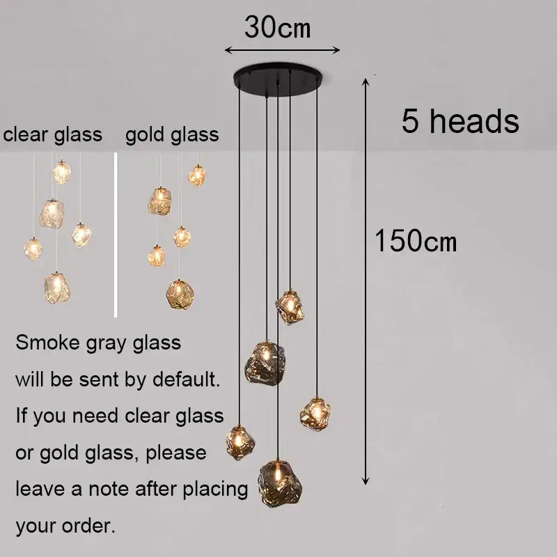 Modern iron and glass 6 light pendant light with five irregular glass globes in clear or gold as a dining room statement piece