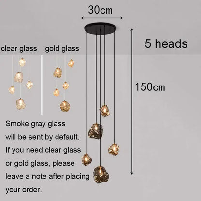 Modern iron and glass 6 light pendant light with five irregular glass globes in clear or gold as a dining room statement piece