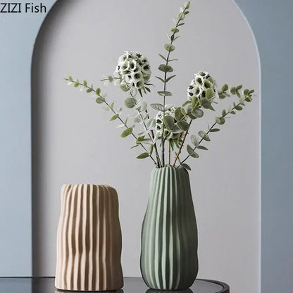 A sleek sage green irregular ceramic vase with ribbed texture from decorbites irregular ceramic vase trio decor