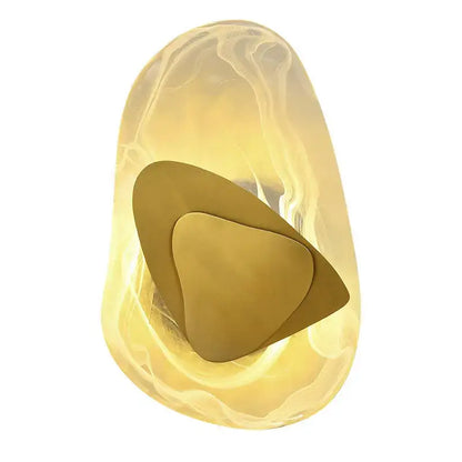 A modern irregular graphic wall light with translucent amber glass and layered gold-toned metal decorbites irregular graphic design