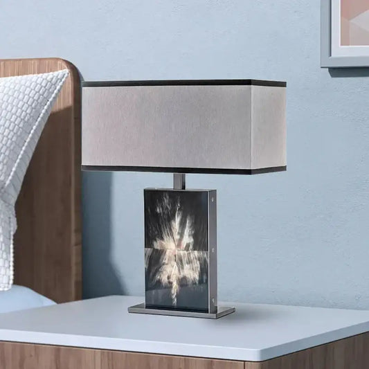 Modern italian luxury table lamp with beige fabric shade and metallic base featuring abstract black and white print by decorbites