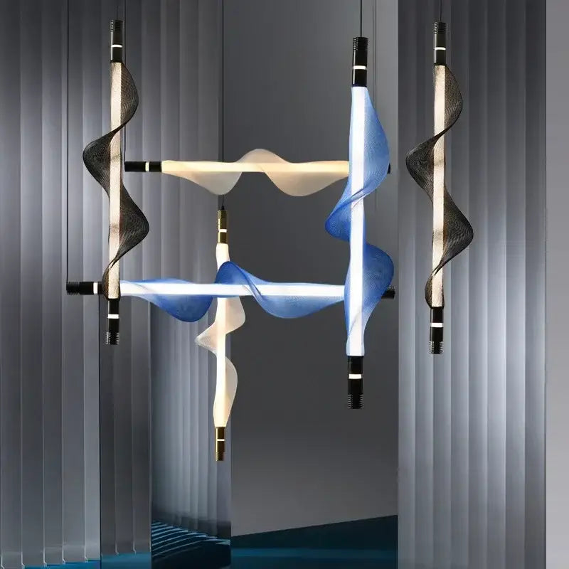 Modern Italian style pendant light with flowing blue and white translucent ribbons suspended from black metal fixtures, decorbites