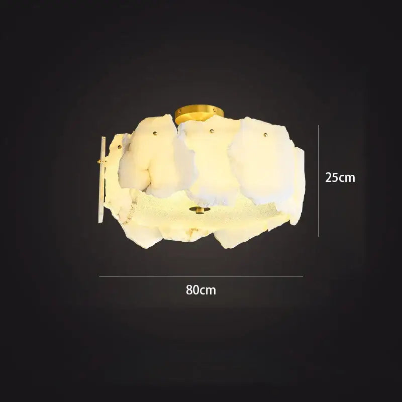 Modern ceiling light with frosted ivory white marble cloud-like shade and gold-toned decorbites ivory white accents