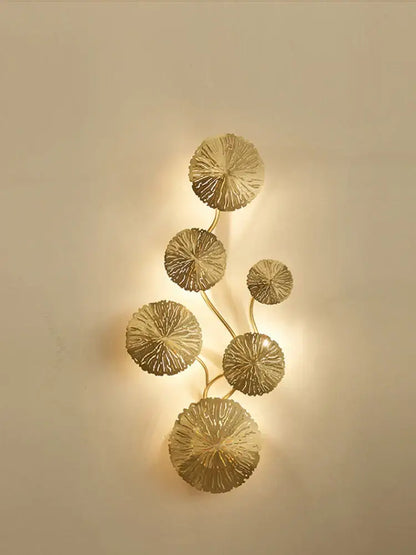 Modern leaf gold iron wall sconce with intricately detailed circular leaf elements in a vertical vine pattern by decorbites iron wall