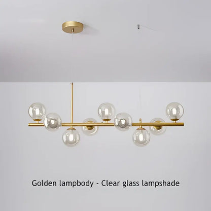 Golden pendant light with clear glass globe shades on a modern chandelier by decorbites featuring a head ring design