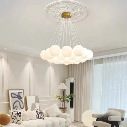 A modern cloud-shaped luxury led pendant light with frosted white glass balls and gold ceiling fixture for living room use