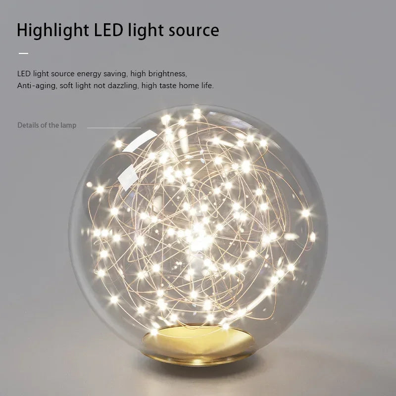A modern led ceiling chandelier with spherical glass lamp and golden base featuring glowing white led lights