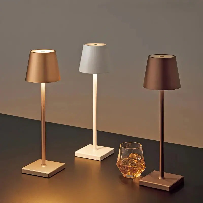 Three sleek modern led mosaic table lamps with cylindrical shades in gold white and bronze for bedroom use