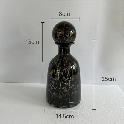 Elegant black glass decanter with glossy marbled finish and spherical stopper featuring decorbites leopard texture design