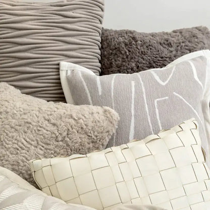 A cream-colored woven leather cushion cover with geometric grid pattern for decorbites light grey coffee decor