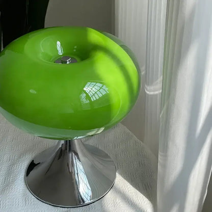 Modern lime green resin stool with a vibrant green glass desk lamp and polished chrome base for decorbites glass desk use