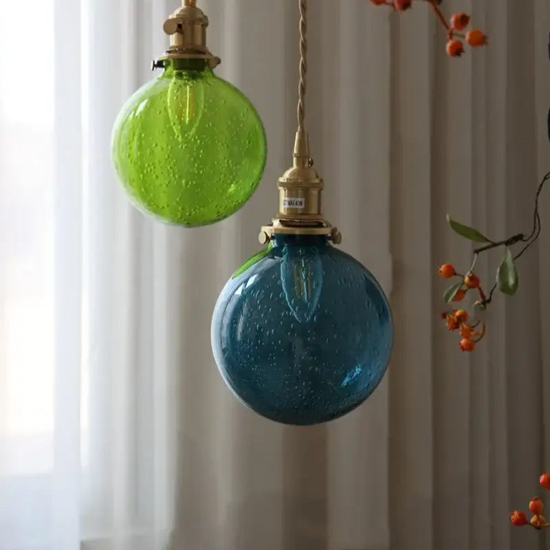 Modern lime and teal blue decorbites bubble glass pendant light with textured bubble glass ball and brass fixtures for dining room