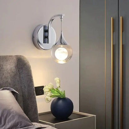 Modern luxurious crystal led wall sconce with chrome finish and teardrop glass globe for elegant bedroom lighting