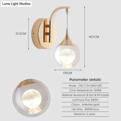 Modern luxurious crystal led wall sconce with gold curved metal arm and teardrop glass globe for bedroom lighting