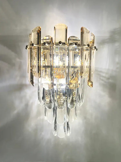 Modern luxury crystal gold led wall sconce with cascading clear amber prisms on a polished metal decorbites crystal gold frame