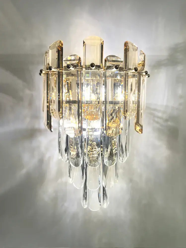 Modern luxury crystal gold led wall sconce with cascading clear amber prisms on a polished metal decorbites crystal gold frame