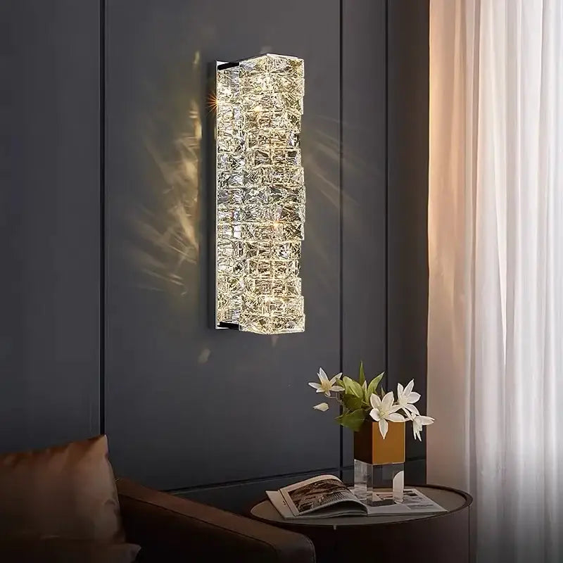 Modern luxury gold and crystal led wall light with textured design emitting warm light for living room use