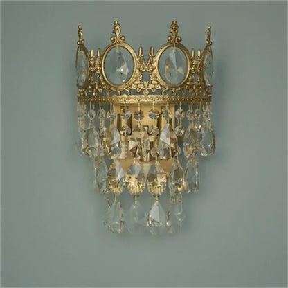 Gold-toned crystal crown chandelier wall sconce with dangling crystal droplets by decorbites for elegant living room decor