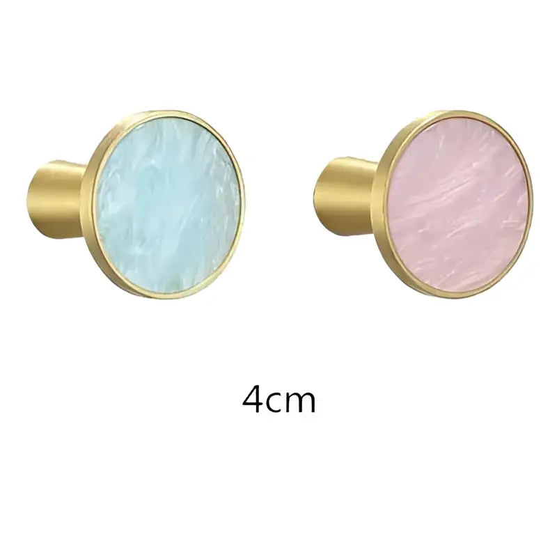 A pair of 4cm brushed gold towel hook cabinet knobs with smooth light blue and pink marbled stone inlays decorbites brushed gold