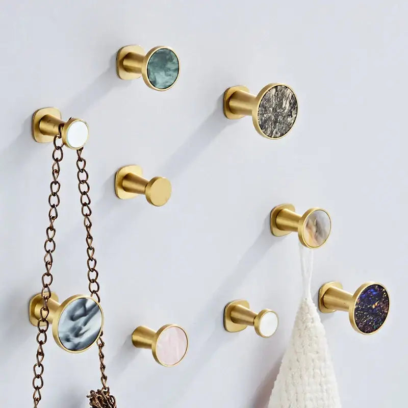 Modern marbled stone towel hook with decorbites brushed gold finish and circular mother of pearl inlays for bathroom decor